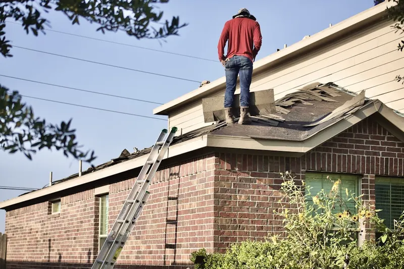 Professional roofer working on a residential roof in New Milford